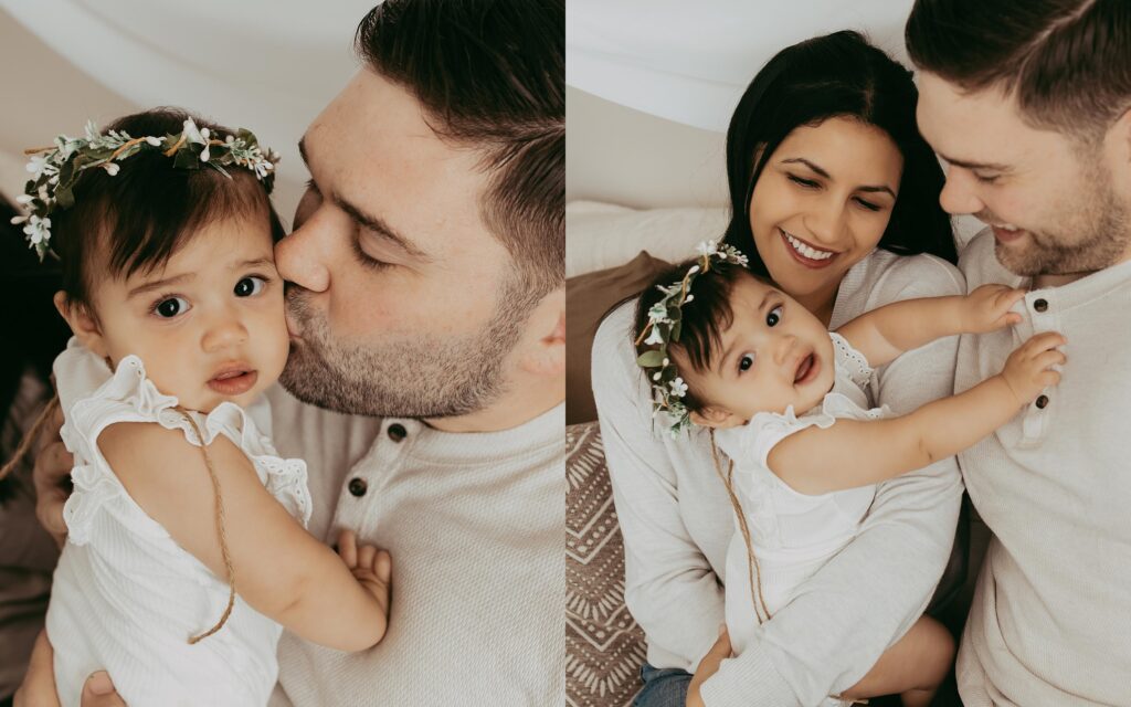 Family picture of parents holding their daughter. 